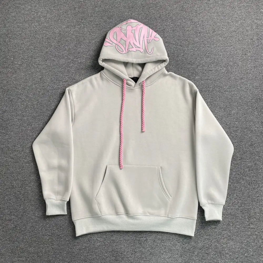 Light grey oversized hoodie with pink graffiti graphic print on the hood and pink drawstrings, laid flat