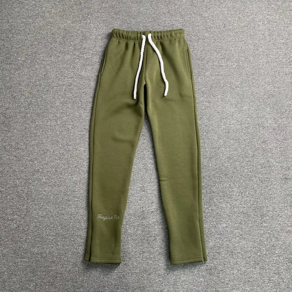 Olive green drawstring jogger pants with script embroidery on lower leg, laid flat on grey background