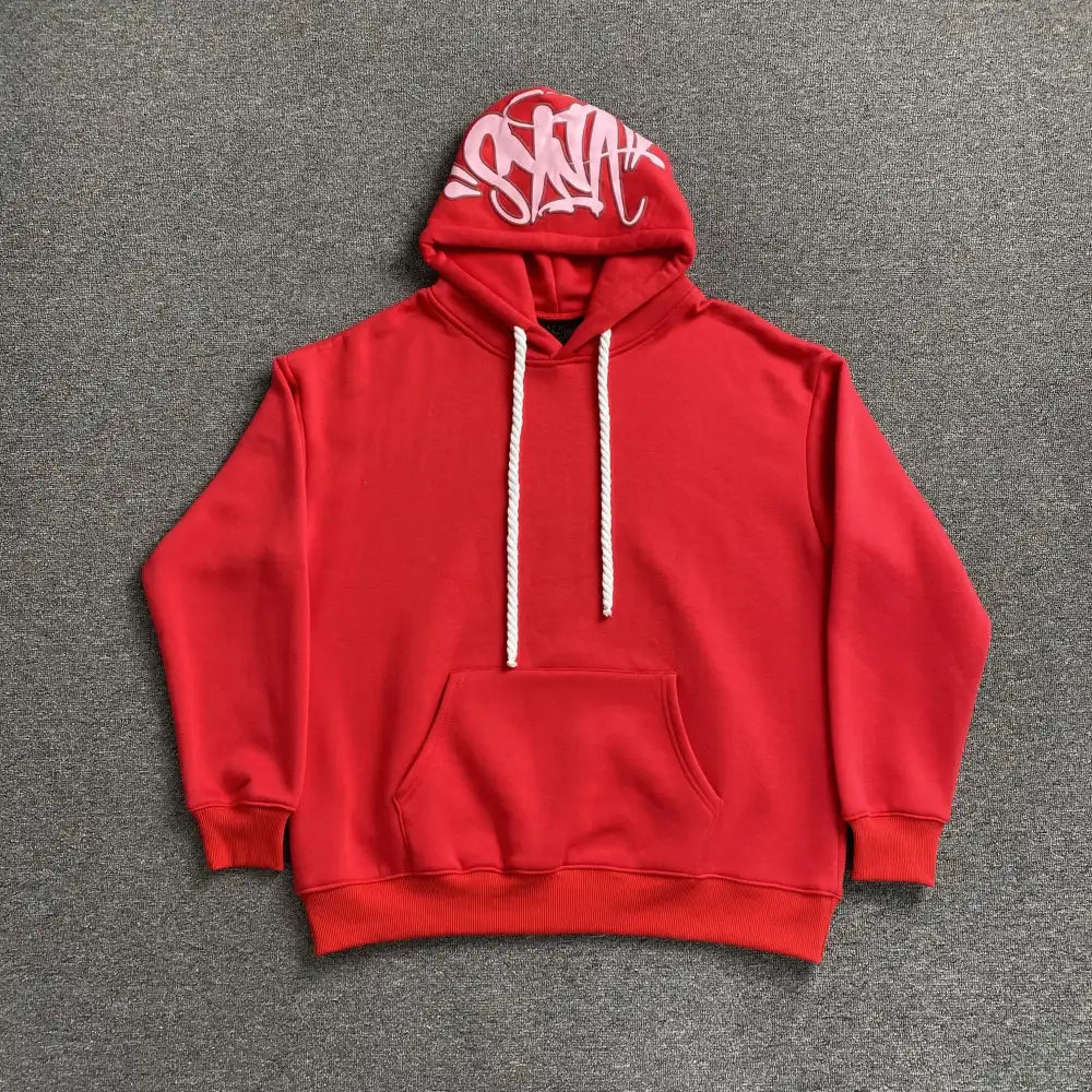 Red pullover hoodie with graffiti letter graphic on hood brim, front kangaroo pocket and twisted rope drawstring