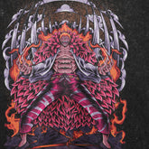 A One Piece-inspired Seakoff tee features a stylized Donquixote Doflamingo "Heavenly Demon" design. The washed black oversized shirt captures a muscular, fiery-haired man with blazing swords, surrounded by flames and abstract elements.