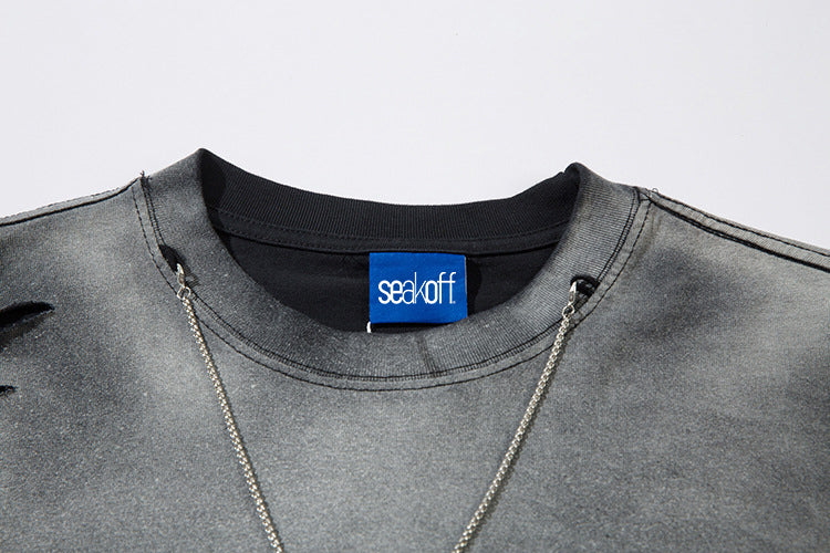 A close-up showcases the Limited Edition Death Note Long Sleeve Shirt, featuring a gray distressed design and black collar, with anime streetwear flair. A blue &quot;seal off&quot; tag graces the neck, enhancing its allure. Two thin silver chains drape elegantly over this unique piece by Death Note.