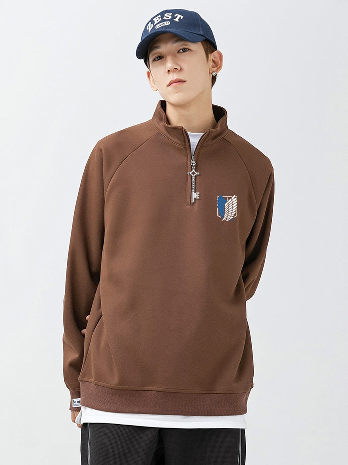 A young person wears a navy cap with the Attack on Titan Limited Edition Half-Zip Sweatshirt featuring the Scout Regiment logo and Eren’s Key Zipper pull, layered over a crisp white shirt against a plain background.